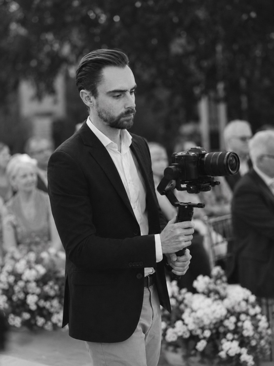 Jorge filming a wedding ceremony with a camera and gimbal